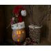 This image shows Dingle the elf with a battery-operated candle lighting up his smile and snowflakes carved into the shell.